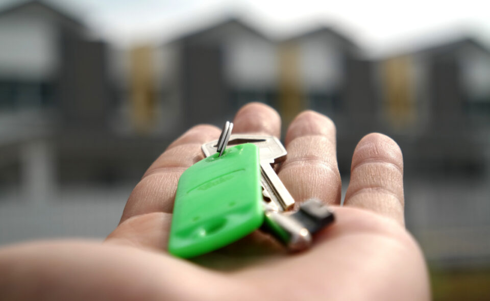 open hand holding house keys